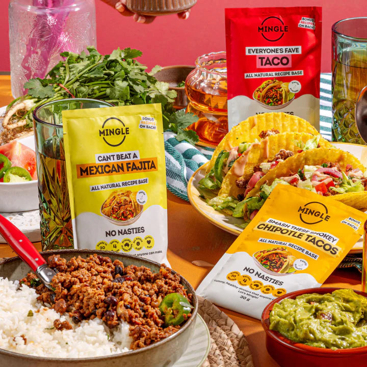 Keto Store NZ | Mingle Recipe Mixes | Mexican Fiesta for all the flavours | Mingle Taco Seasoning packets with a taco meal setup on a table.